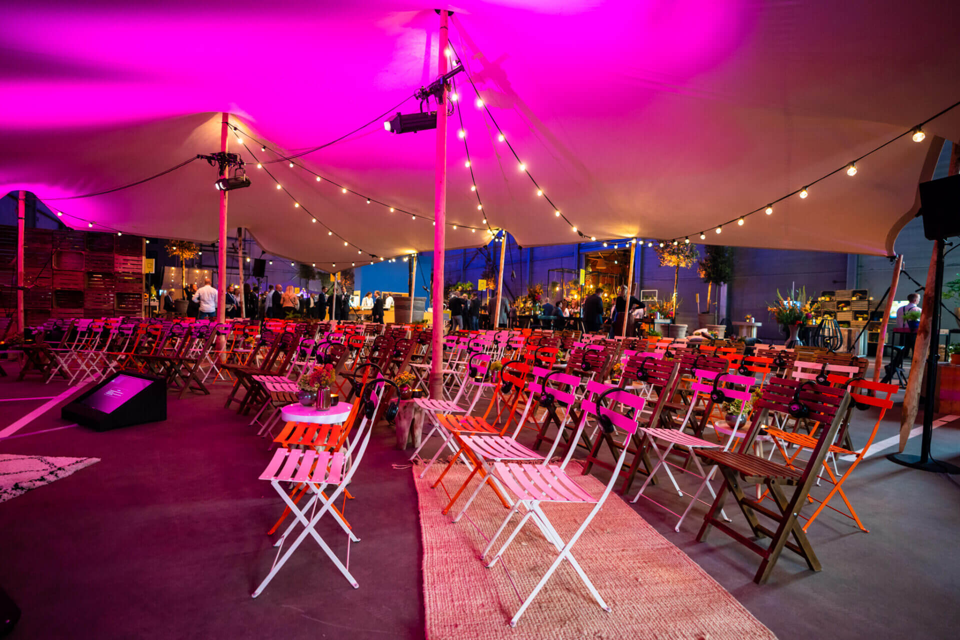 indoor stretchtent met klapstoelen en kleurrijke verlichting